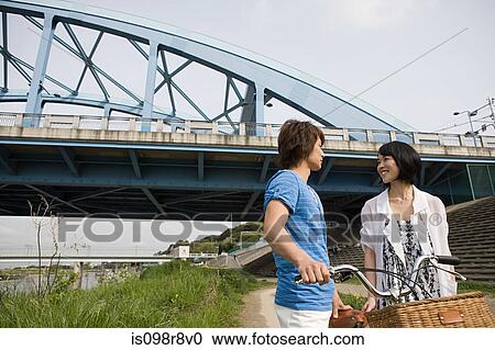 Stock Image - Young couple with bicycle. Fotosearch