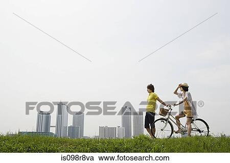 Stock Image - Young couple with bicycle. Fotosearch