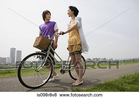Stock Photo - Young couple with bicycle. Fotosearch