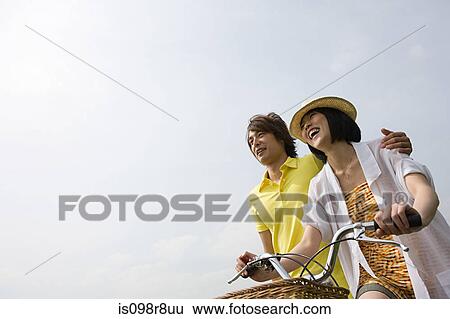 Young couple with bicycle View Large Photo Image Stock Photograph - Young couple with bicycle. Fotosearch