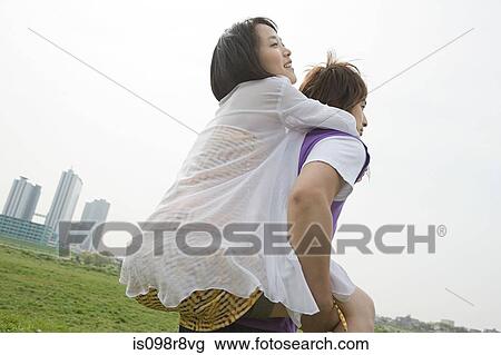 Young man giving girlfriend piggyback View Large Photo Image Stock Image - Young man giving girlfriend piggyback. Fotosearch