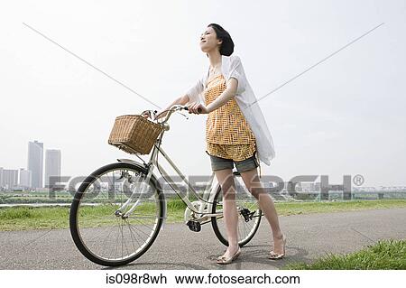 Young woman with bicycle View Large Photo Image Stock Image - Young woman with bicycle. Fotosearch