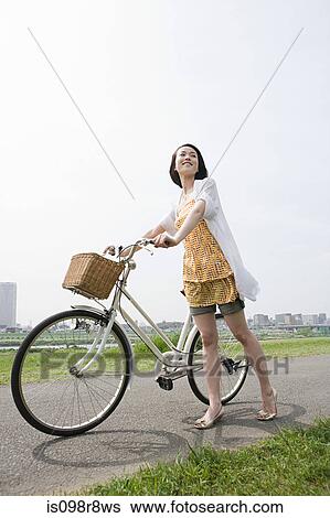 Young woman with bicycle View Large Photo Image Stock Photograph - Young woman with bicycle. Fotosearch