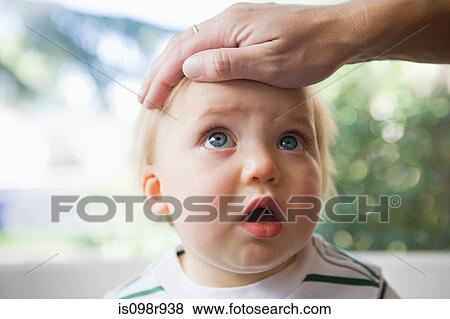 Adult hand on head of baby View Large Photo Image Stock Photo - Adult hand on head of baby. Fotosearch
