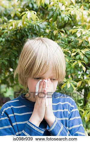 Boy blowing his nose View Large Photo Image Stock Photo - Boy blowing his nose. Fotosearch