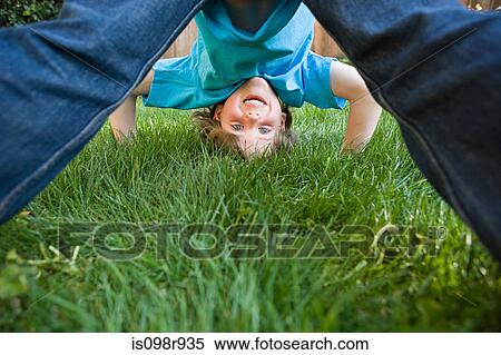 Boy playing on grass View Large Photo Image Stock Photography - Boy playing on grass. Fotosearch