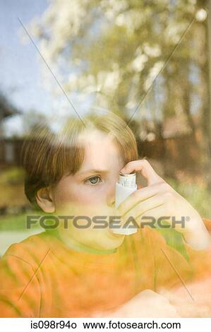 Boy taking asthma inhaler View Large Photo Image Picture - Boy taking asthma inhaler. Fotosearch