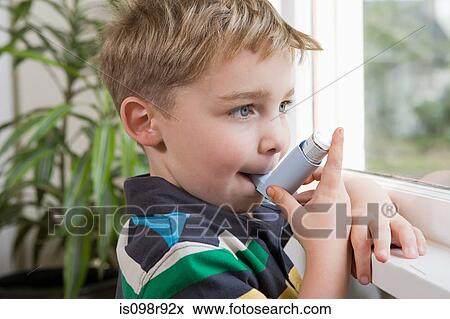 Boy taking asthma inhaler View Large Photo Image Stock Photo - Boy taking asthma inhaler. Fotosearch