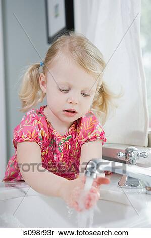 Girl washing her hands View Large Photo Image Stock Photography - Girl washing her hands. Fotosearch