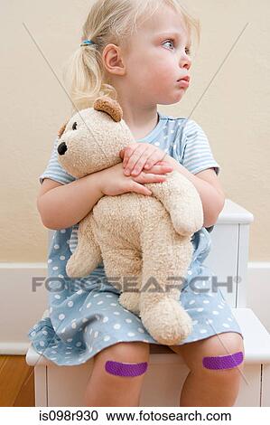 Girl with teddy bear and plasters on knees View Large Photo Image Stock Image - Girl with teddy bear and plasters on knees. Fotosearch