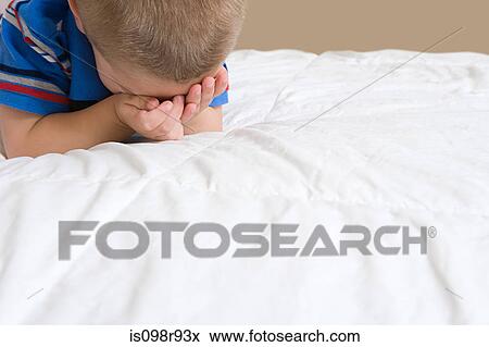 Little boy crying on bed View Large Photo Image Stock Photo - Little boy crying on bed. Fotosearch