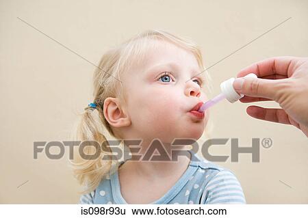 Little girl being given medicine View Large Photo Image Stock Photograph - Little girl being given medicine. Fotosearch