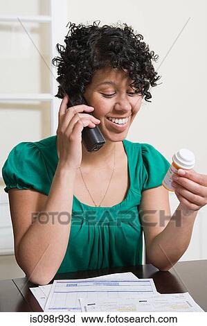 Woman on telephone with medicine View Large Photo Image Stock Image - Woman on telephone with medicine. Fotosearch