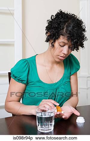 Woman taking pills View Large Photo Image Stock Photography - Woman taking pills. Fotosearch
