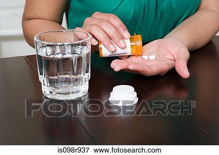 Woman taking tablets View Large Photo Image Stock Photo - Woman taking tablets. Fotosearch