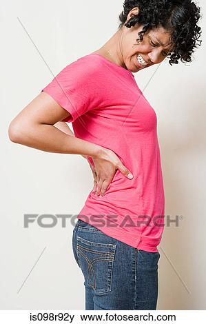 Woman with a backache View Large Photo Image Stock Photo - Woman with a backache. Fotosearch