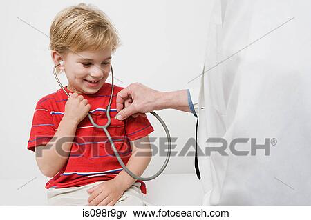 Stock Photo - Boy and doctor with stethoscope. Fotosearch