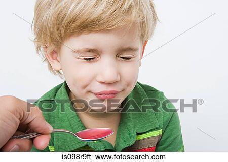 Boy and spoon of medicine View Large Photo Image Stock Photograph - Boy and spoon of medicine. Fotosearch