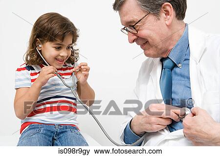 Stock Photo - Girl and doctor with stethoscope. Fotosearch