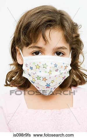 Stock Photograph - Girl in a protective mask. Fotosearch