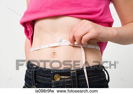 Girl measuring waist View Large Photo Image Stock Photo - Girl measuring waist. Fotosearch