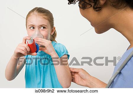 Stock Image - Girl taking asthma inhaler. Fotosearch
