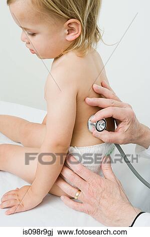 Stock Image - Little boy having medical examination. Fotosearch