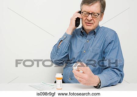 Man on telephone with medicine View Large Photo Image Stock Image - Man on telephone with medicine. Fotosearch