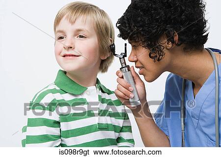 Nurse looking in boys ear View Large Photo Image Stock Photograph - Nurse looking in boys ear. Fotosearch