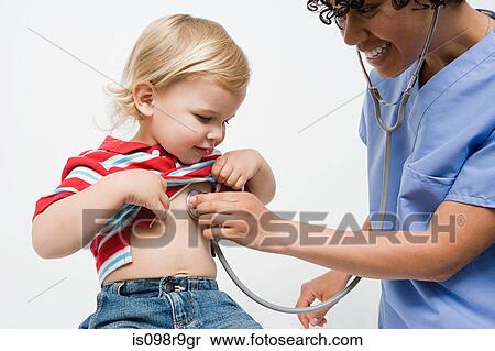 Stock Photography - Toddler and nurse with stethoscope. Fotosearch