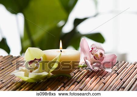 Stock Photograph - Orchid flowers and candle. Fotosearch