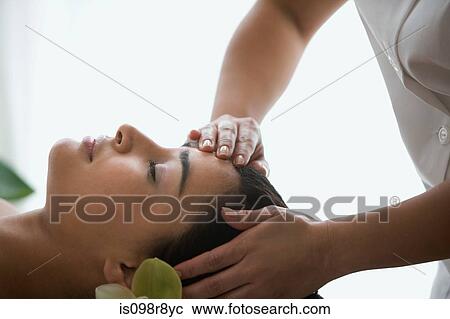 Stock Image - Woman having a head massage. Fotosearch