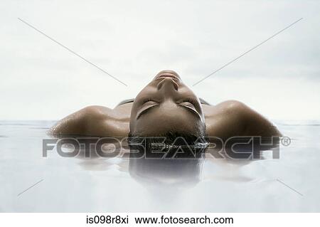 Stock Image - Young woman in water. Fotosearch