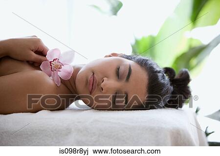 Young woman on massage table with orchid flowers View Large Photo Image Stock Image - Young woman on massage table with orchid flowers. Fotosearch