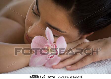 Young woman on massage table with orchid flowers View Large Photo Image Stock Photography - Young woman on massage table with orchid flowers. Fotosearch