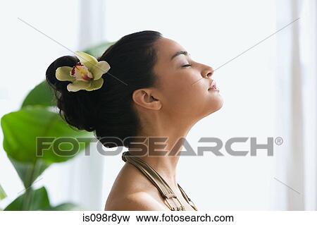 Young woman with flower in hair View Large Photo Image Stock Photo - Young woman with flower in hair. Fotosearch
