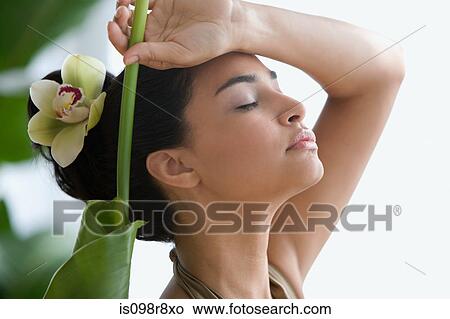 Young woman with leaf and flower in hair View Large Photo Image Picture - Young woman with leaf and flower in hair. Fotosearch
