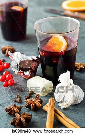 Stock Photo - Mulled wine with spices and chocolates. Fotosearch