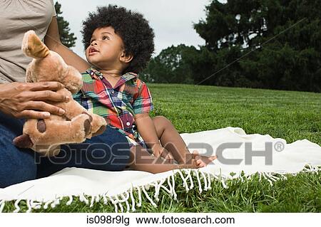 Baby and mother on blanket in park View Large Photo Image Stock Image - Baby and mother on blanket in park. Fotosearch
