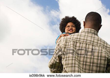 Baby being carried by father View Large Photo Image Stock Image - Baby being carried by father. Fotosearch