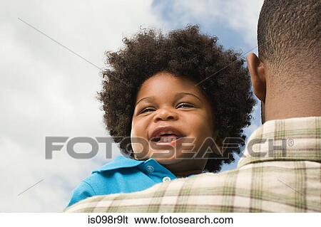 Baby being carried by father View Large Photo Image Stock Photograph - Baby being carried by father. Fotosearch