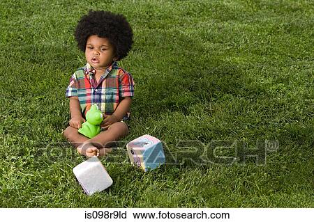 Stock Image - Baby in park with toys. Fotosearch