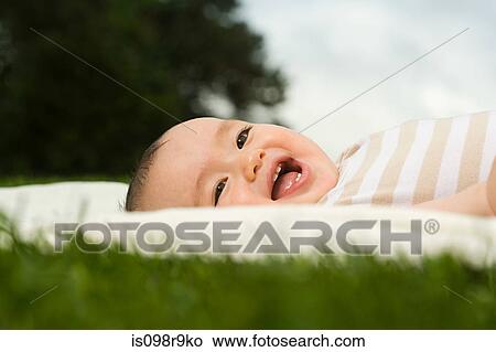 Baby lying on blanket View Large Photo Image Picture - Baby lying on blanket. Fotosearch