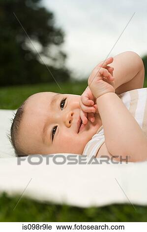 Baby lying on blanket View Large Photo Image Stock Image - Baby lying on blanket. Fotosearch