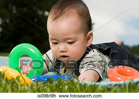 Baby playing with plastic rings View Large Photo Image Stock Image - Baby playing with plastic rings. Fotosearch