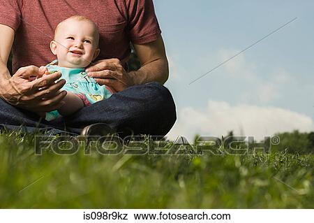Stock Photo - Father with baby girl on lap. Fotosearch