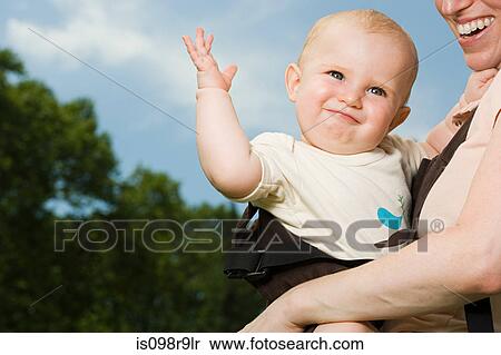 Stock Photography - Mother carrying baby. Fotosearch