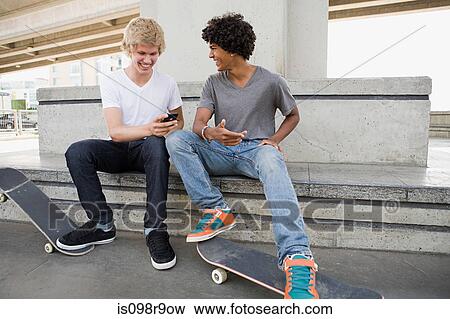 Teenage boys with skateboards and cellphone View Large Photo Image Stock Photo - Teenage boys with skateboards and cellphone. Fotosearch