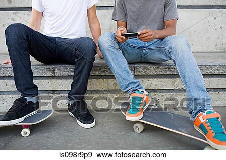Teenage boys with skateboards and cellphone View Large Photo Image Stock Photo - Teenage boys with skateboards and cellphone. Fotosearch