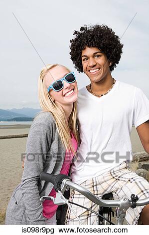 Teenage couple with bicycle View Large Photo Image Stock Image - Teenage couple with bicycle. Fotosearch